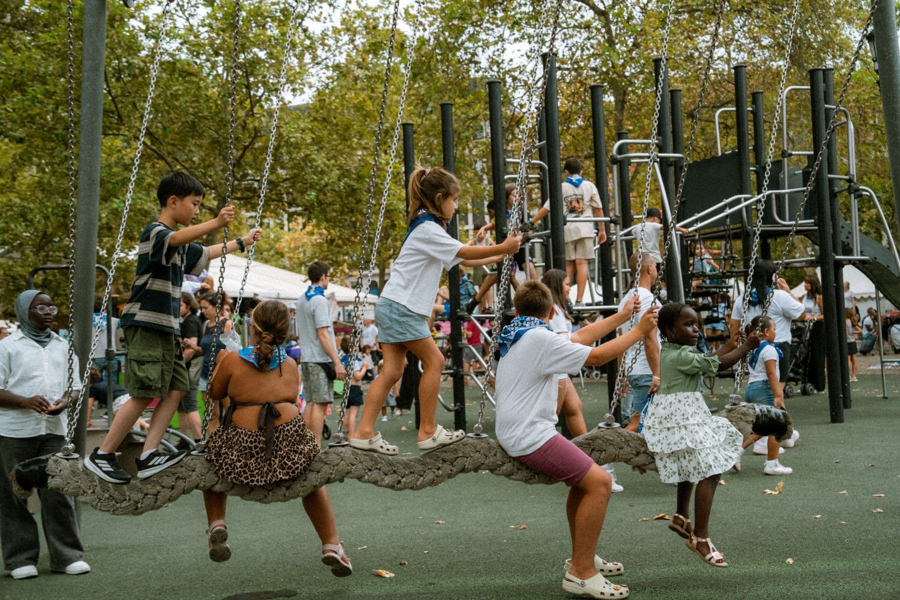 A diverse group of children playing together on playground equipment